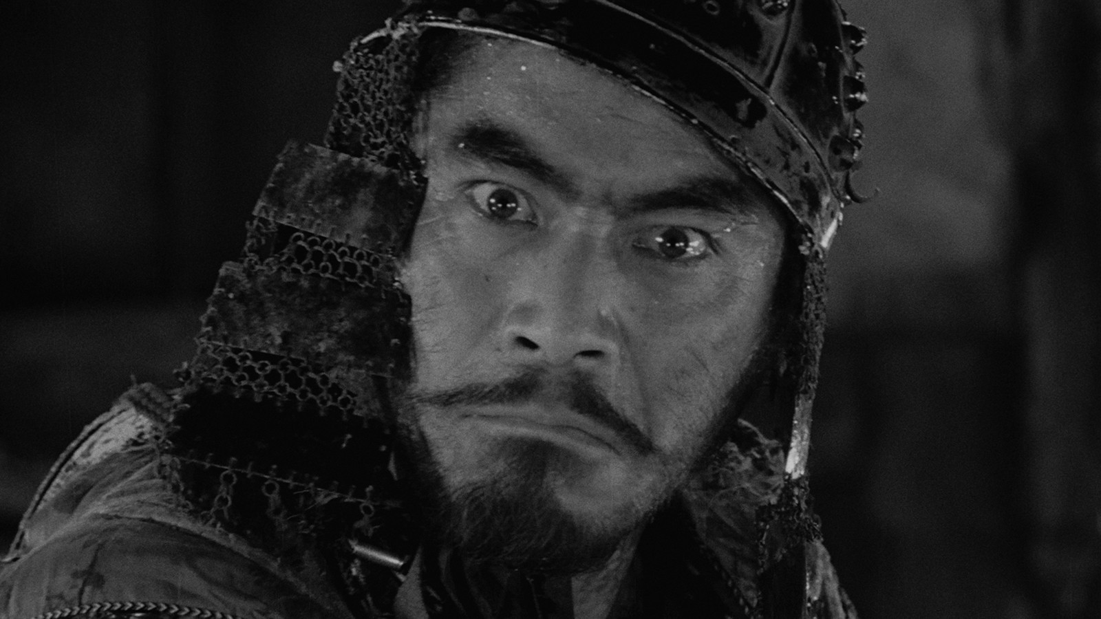 Toshiro Mifune as Kikuchiyo wearing armor in a Seven Samurai still.