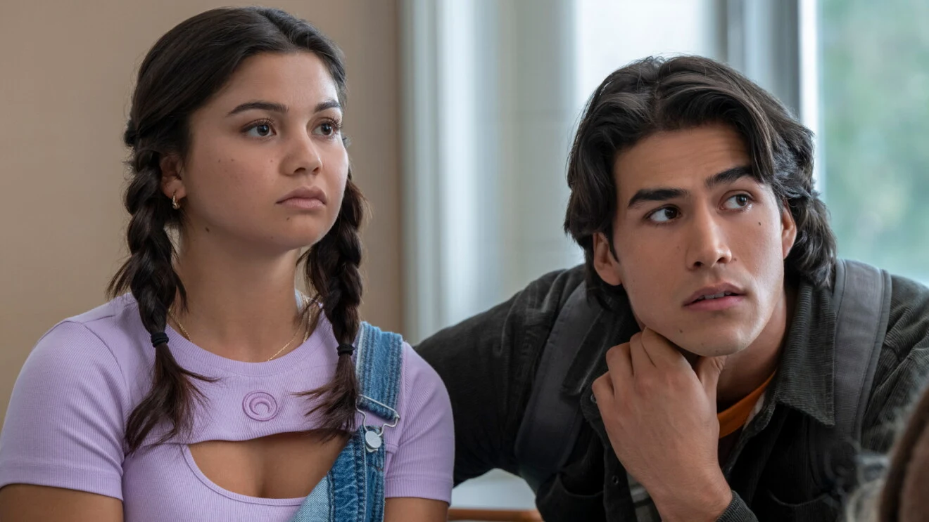 Siena Agudong as Sue Snell and Joel Oulette as Tommy Ross sitting together at school in Carrie.