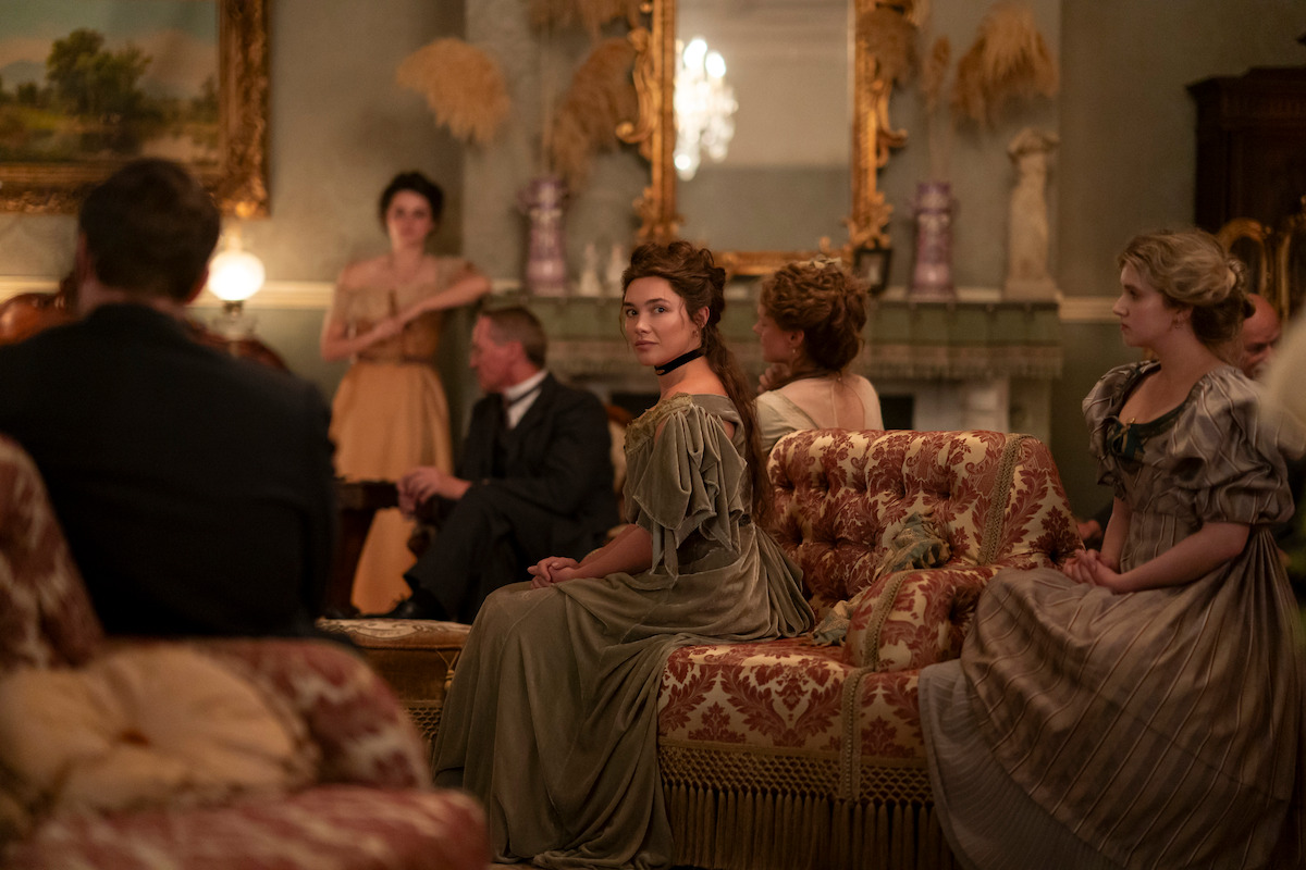 Florence Pugh as Cathy Ames sitting in an ornate room in Netflix's East of Eden.
