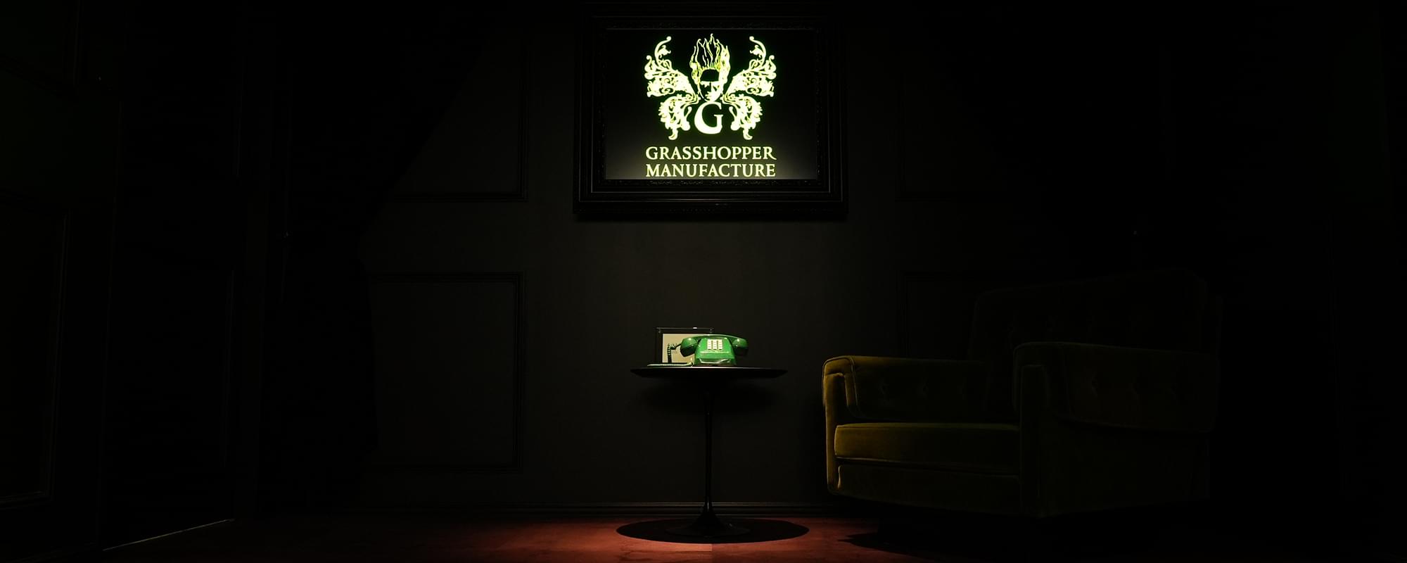 Grasshopper Manufacture's company space, with its illuminated logo above a green telephone.