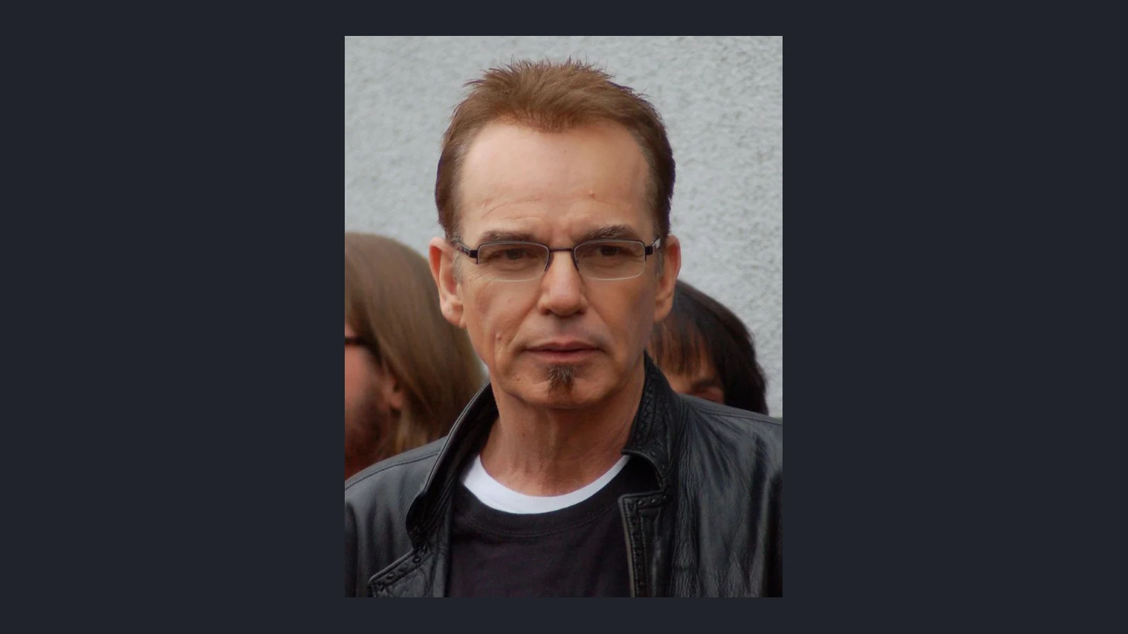 Billy Bob Thornton wearing a dark jacket and tinted glasses at a public event in 2012.