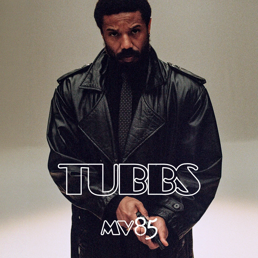 Michael B. Jordan as Ricardo Tubbs faces the camera in a black leather coat in Universal Pictures’ first official Miami Vice ’85 character image.
