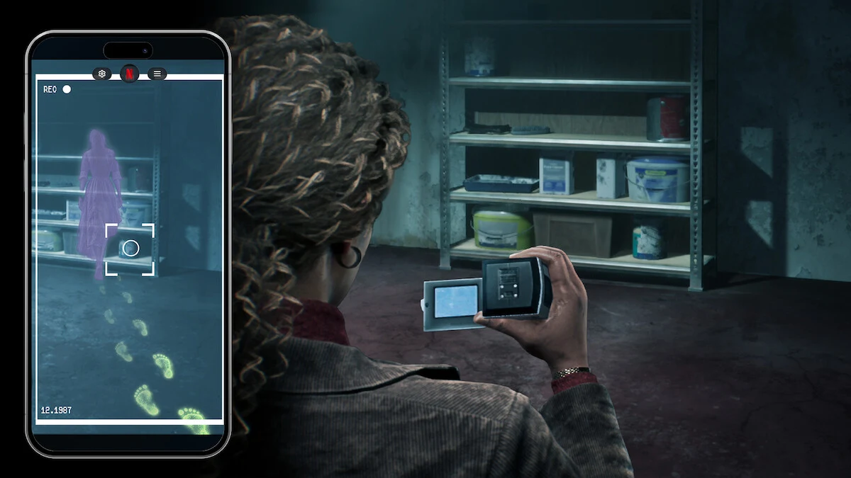 Official The Conjuring: Unspoken promotional image pairs an investigator holding a camera in a storage room with a phone screen showing a purple apparition and footprints.