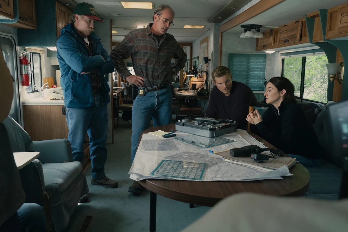 The fictional FBI team studies maps inside an RV in Netflix’s UNABOMBER.